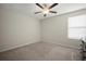 Neutral bedroom with carpet, ceiling fan and a window for natural light at 1823 Moon Cactus Ct, Ruskin, FL 33570