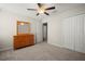 Neutral bedroom with carpet, ceiling fan and wood dresser at 1823 Moon Cactus Ct, Ruskin, FL 33570