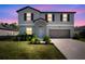 Charming two-story home featuring a well-maintained lawn and a two-car garage at 1823 Moon Cactus Ct, Ruskin, FL 33570
