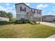 Charming two-story home featuring a well-maintained lawn and a two-car garage at 1823 Moon Cactus Ct, Ruskin, FL 33570