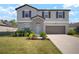 Charming two-story home featuring a well-maintained lawn and a two-car garage at 1823 Moon Cactus Ct, Ruskin, FL 33570