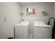 Laundry room with side by side washer and dryer, and overhead storage at 1823 Moon Cactus Ct, Ruskin, FL 33570