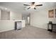 Spacious loft area with carpet, a ceiling fan, ample space for relaxation, and a small refrigerator at 1823 Moon Cactus Ct, Ruskin, FL 33570