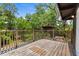 Inviting back deck with wooden railings offering a view of the lush greenery at 18816 Carr Dr, Lutz, FL 33559