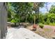 Back patio with string lights, palm trees and ample greenery, creating a serene outdoor space at 18816 Carr Dr, Lutz, FL 33559