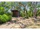 Backyard area with comfortable seating around a fire pit and a shed at 18816 Carr Dr, Lutz, FL 33559
