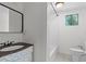 Cozy bathroom featuring a vanity, mirror, tub and subway tile at 18816 Carr Dr, Lutz, FL 33559