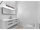 Clean bathroom with a vanity, a large mirror, and a toilet at 18816 Carr Dr, Lutz, FL 33559