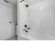 Bathroom with subway tile surround, shower/tub, and storage cabinet at 18816 Carr Dr, Lutz, FL 33559