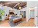 Cozy main bedroom features a high ceiling, wood beam and modern decor at 18816 Carr Dr, Lutz, FL 33559