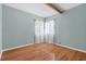 Empty bedroom with hardwood floors, neutral walls, and a window at 18816 Carr Dr, Lutz, FL 33559