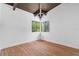 Empty bedroom featuring wood floors, white walls and a corner window with natural light at 18816 Carr Dr, Lutz, FL 33559
