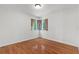 Empty bedroom with hardwood floors, neutral walls, and a window at 18816 Carr Dr, Lutz, FL 33559