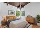 Neutral bedroom with a bed with a light wood frame and a corner window with nature views at 18816 Carr Dr, Lutz, FL 33559