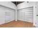Spacious walk-in closet with custom shelving and wood floor at 18816 Carr Dr, Lutz, FL 33559