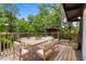Outdoor dining area featuring a wooden table, chairs and lush surroundings at 18816 Carr Dr, Lutz, FL 33559
