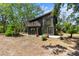 Beautiful home with large windows, wooden accents, balcony, and landscaped yard at 18816 Carr Dr, Lutz, FL 33559