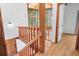 Hallway featuring wood flooring and a staircase with a wooden banister overlooking a sunroom at 18816 Carr Dr, Lutz, FL 33559