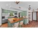 Kitchen featuring butcher block island, stainless appliances, and sage green cabinetry at 18816 Carr Dr, Lutz, FL 33559