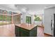 Bright kitchen features a center wooden island, tile flooring and an eat in area at 18816 Carr Dr, Lutz, FL 33559