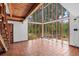 Bright living area featuring hardwood flooring, a vaulted ceiling and large windows at 18816 Carr Dr, Lutz, FL 33559