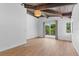 Spacious main bedroom with wood floors, bright lighting, and balcony access at 18816 Carr Dr, Lutz, FL 33559