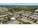 An aerial shot presents the community pool nestled in a luxurious condo community with lake views in the distance at 2131 River Turia Cir, Riverview, FL 33578