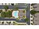An aerial view shows the community pool and clubhouse, with plenty of parking and mature trees surrounding at 2131 River Turia Cir, Riverview, FL 33578