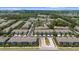 An aerial view showcases the beautiful condo community surrounded by lush trees and two ponds in the distance at 2131 River Turia Cir, Riverview, FL 33578
