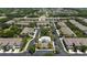 Aerial view of a community with residential buildings, a pool, and lush greenery at 2131 River Turia Cir, Riverview, FL 33578