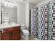 Bathroom featuring a vanity with mirror, toilet, and patterned shower curtain at 2131 River Turia Cir, Riverview, FL 33578