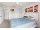 Bright bedroom featuring a bed, ceiling fan, closet and wall art at 2131 River Turia Cir, Riverview, FL 33578