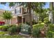 Exterior view of a townhome surrounded by lush landscaping on a sunny day at 2131 River Turia Cir, Riverview, FL 33578