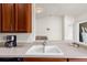Kitchen sink with counterspace looking into the living room and access to the balcony at 2131 River Turia Cir, Riverview, FL 33578