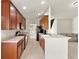 Galley kitchen with wood cabinets, tile flooring, and stainless steel appliances at 2131 River Turia Cir, Riverview, FL 33578