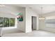 Bright living area with a mounted TV, access to the balcony, and neutral color palette at 2131 River Turia Cir, Riverview, FL 33578