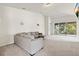 Cozy living room with a plush gray sofa and sliding glass doors to the balcony at 2131 River Turia Cir, Riverview, FL 33578