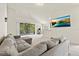 Inviting living room featuring a comfortable sofa, balcony access, and a mounted television at 2131 River Turia Cir, Riverview, FL 33578