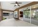 View of the outdoor patio featuring a ceiling fan and sliding glass doors to the kitchen at 2131 River Turia Cir, Riverview, FL 33578