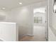 Upstairs hallway with carpeted floors and a bedroom entrance at 2131 River Turia Cir, Riverview, FL 33578