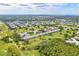 Expansive aerial view of the golf course, ponds, and residences at 2287 Philippine Dr # 29, Clearwater, FL 33763
