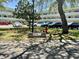 Exterior view of a condo complex with lush greenery, a community sign, and visible parking at 2287 Philippine Dr # 29, Clearwater, FL 33763