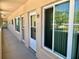 Exterior hallway showcasing unit doors, windows, and access to residential units in a low rise condo at 2287 Philippine Dr # 29, Clearwater, FL 33763