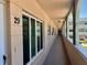 Exterior hallway with multiple unit entrances, arched supports, and common area lighting at 2287 Philippine Dr # 29, Clearwater, FL 33763