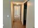 Neutral-toned hallway with sliding closet door and multiple entryways at 2287 Philippine Dr # 29, Clearwater, FL 33763