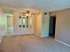 Spacious living room featuring a mirror wall, carpet floors, and open access to other areas at 2287 Philippine Dr # 29, Clearwater, FL 33763