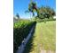 Well-maintained backyard with lush green grass and privacy hedges at 2310 Medford Ln, Brandon, FL 33511