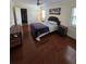 Well-lit bedroom with hardwood floors, neutral colors, and comfortable bed at 2310 Medford Ln, Brandon, FL 33511