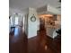 Open-concept foyer with hardwood floors flowing into the kitchen featuring stainless steel appliances and granite countertops at 2310 Medford Ln, Brandon, FL 33511