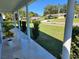 Charming front porch with tiled floor and landscaped front yard at 2310 Medford Ln, Brandon, FL 33511